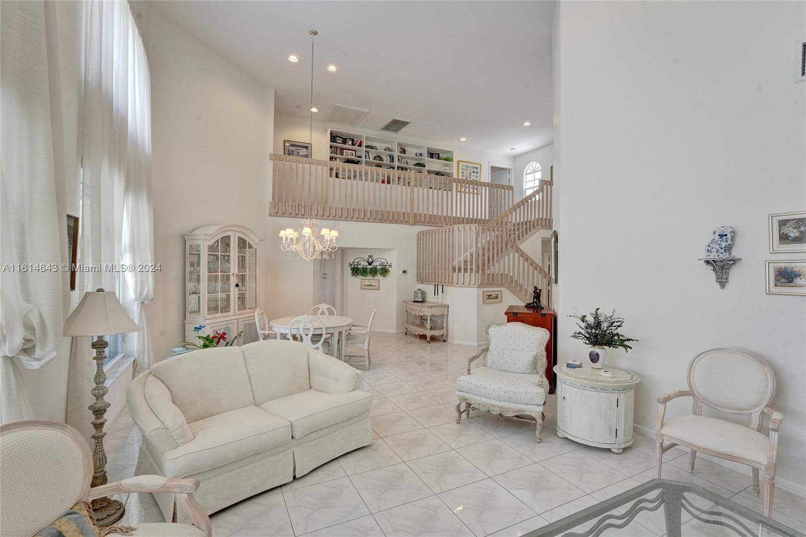 17269 Balboa Point Way Boca Raton, FL 33487 - Photo 10 of 41 a living room with furniture and a chandelier