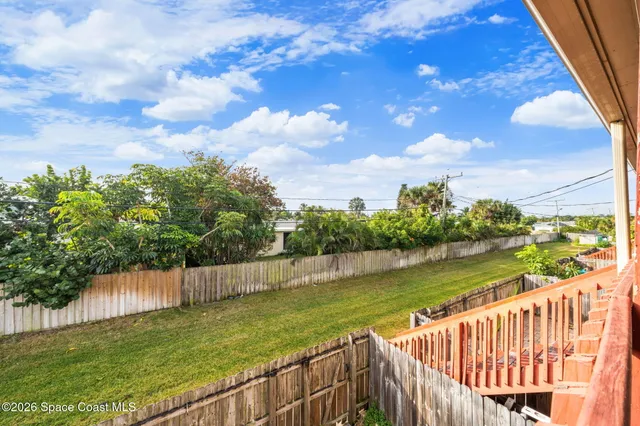 a view of deck and lake with wooden fence