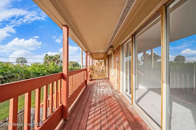 a view of balcony with wooden floor