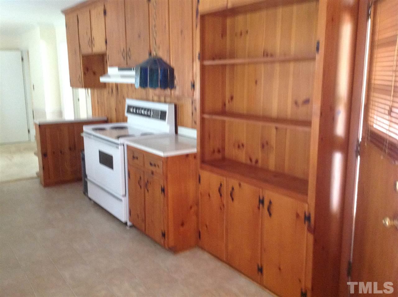 145 Creech Road Garner, NC 27529 - Photo 6 of 15 a kitchen with a cabinets and a stove top oven