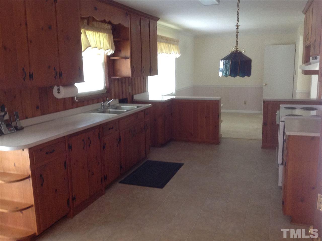 145 Creech Road Garner, NC 27529 - Photo 7 of 15 a kitchen with stainless steel appliances granite countertop a sink a stove and a refrigerator