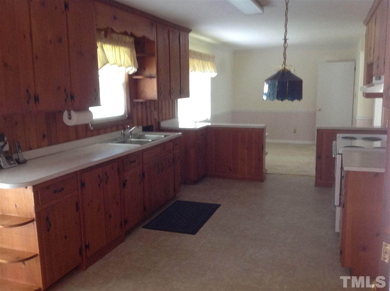 145 Creech Road Garner, NC 27529 - Photo 8 of 15 a kitchen with cabinets and window