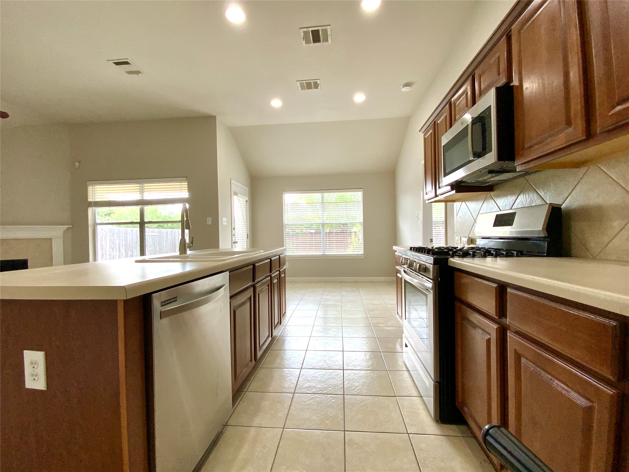 18704 Silent Water Way Pflugerville, TX 78660 - Photo 6 of 14 a kitchen with stainless steel appliances granite countertop a sink and a stove