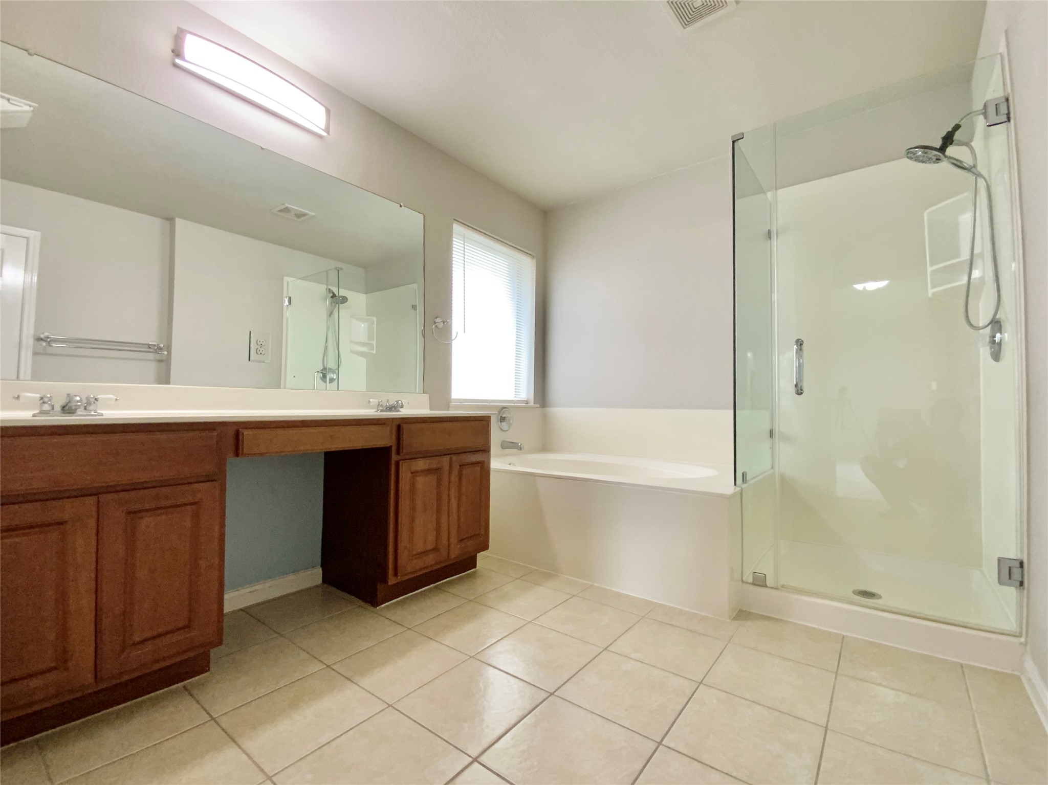 18704 Silent Water Way Pflugerville, TX 78660 - Photo 9 of 14 a bath room with a sink a mirror and a bath tub