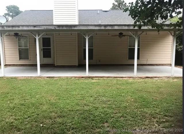 a view of a backyard with hardwood area and garage