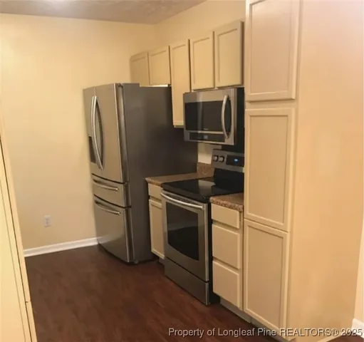 a kitchen with metallic refrigerator freezer and a dishwasher