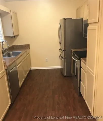a kitchen with a refrigerator and a sink