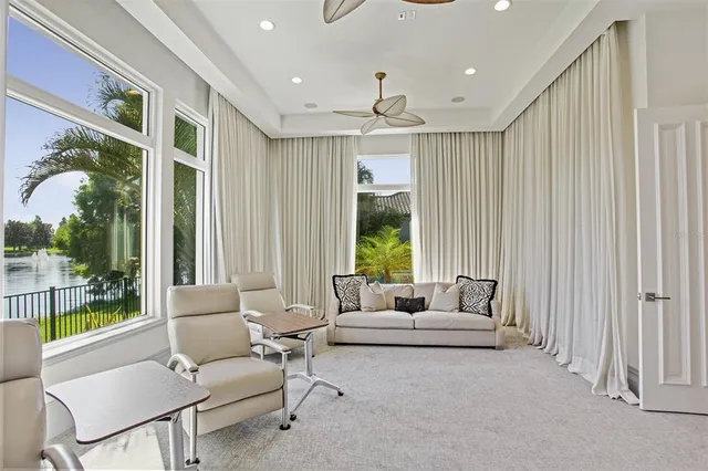 a bedroom with a bed chandelier and a window