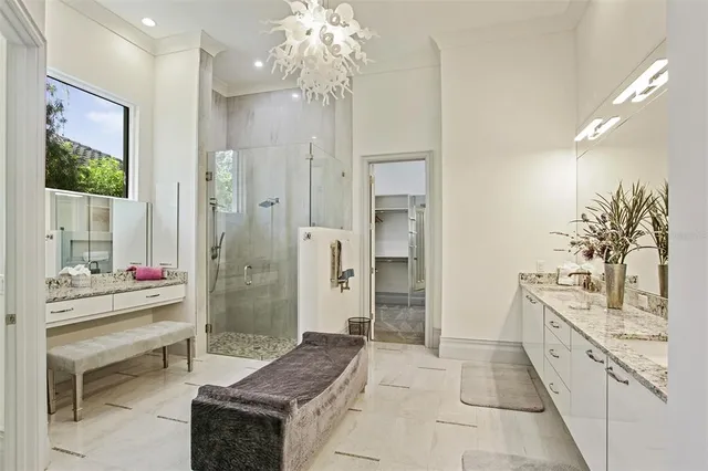 a en suite bathroom with a shower sink and mirror