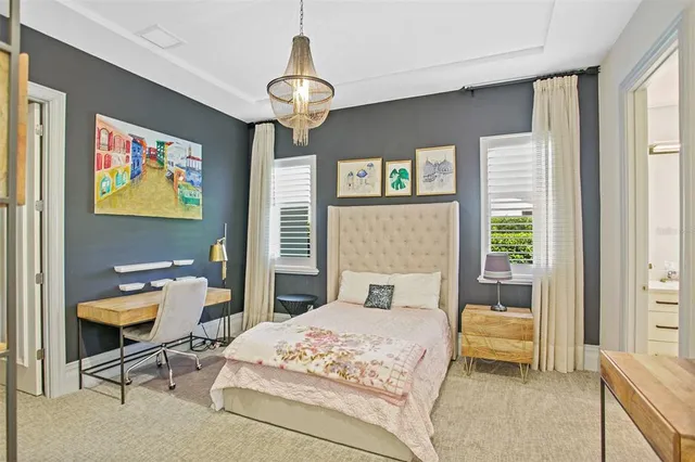 a bedroom with a bed couches and window