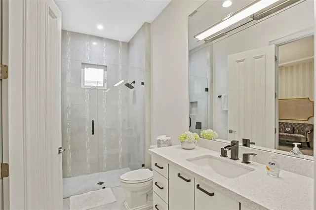 a bathroom with a sink mirror toilet and bathtub