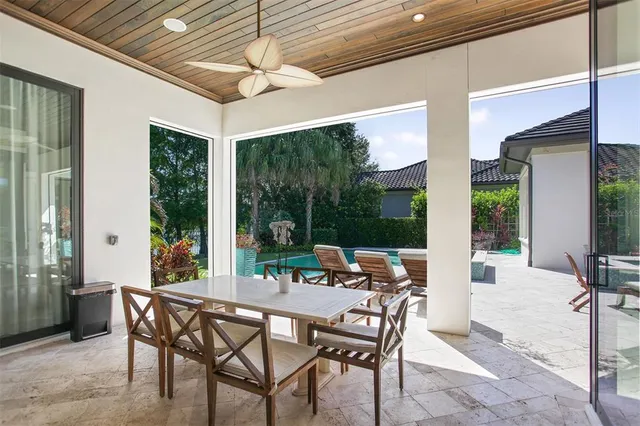 a view of a house with backyard patio and swimming pool