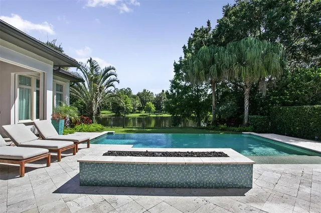 a view of a house with a yard patio and swimming pool