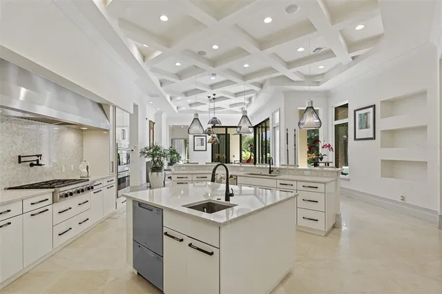 a kitchen with cabinets and chandelier
