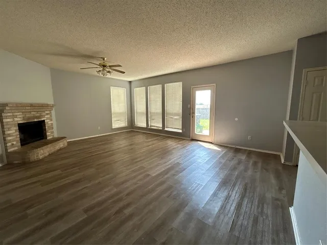 wooden floor in an empty room with a fireplace