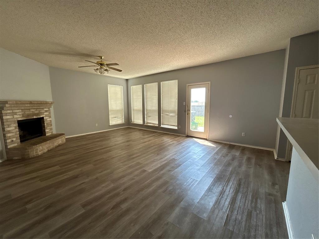 2620 Ridgebrook Court Mesquite, TX 75181 - Photo 1 of 24 wooden floor in an empty room with a fireplace
