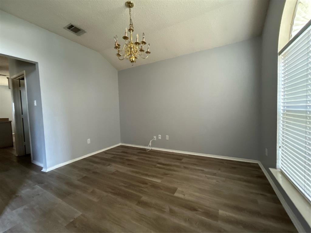 2620 Ridgebrook Court Mesquite, TX 75181 - Photo 15 of 24 an empty room with wooden floor and windows