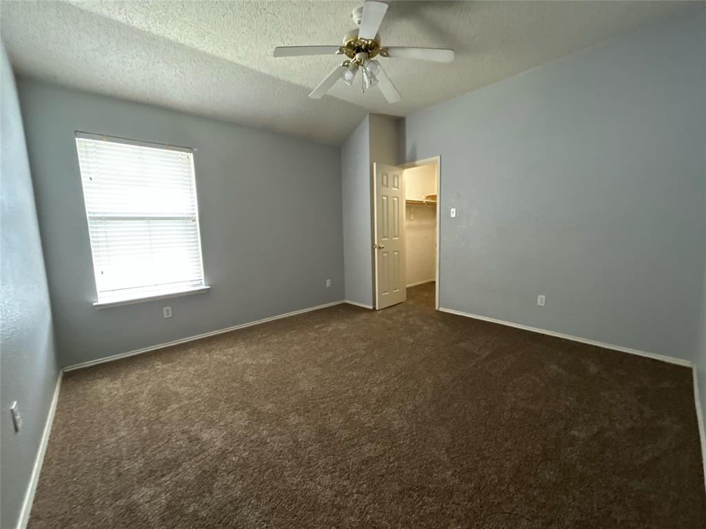 2620 Ridgebrook Court Mesquite, TX 75181 - Photo 20 of 24 an empty room with a window and a ceiling fan