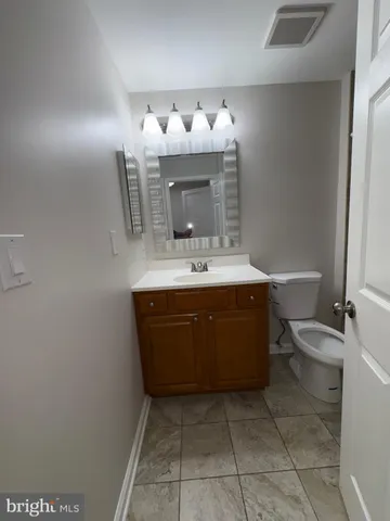 a bathroom with a sink a mirror and a toilet