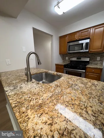 a kitchen with a stove a sink and a microwave