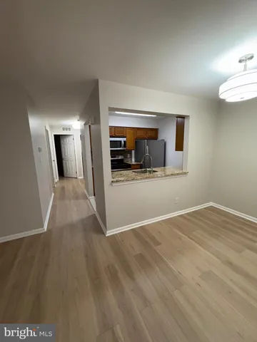 a view of a big room with wooden floor and fire place
