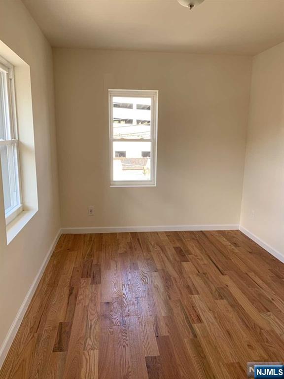145 Kinderkamack Road Park Ridge, NJ 07656 - Photo 14 of 15 an empty room with wooden floor and windows
