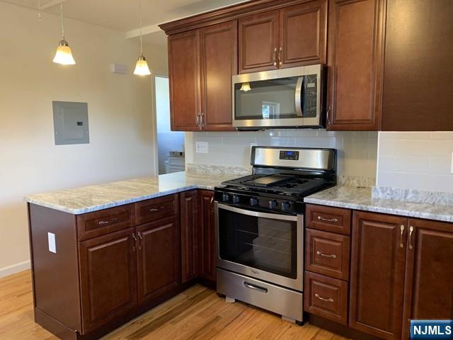 145 Kinderkamack Road Park Ridge, NJ 07656 - Photo 3 of 15 a kitchen with granite countertop a stove and a microwave