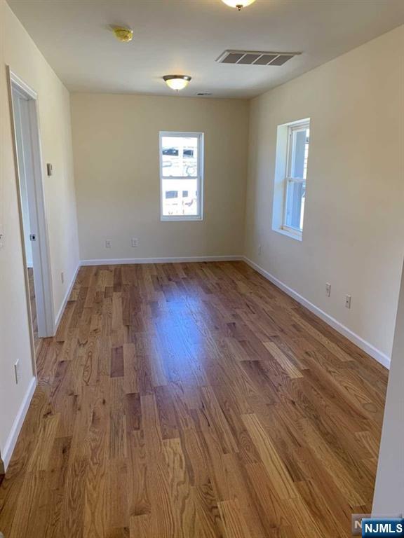145 Kinderkamack Road Park Ridge, NJ 07656 - Photo 9 of 15 wooden floor in an empty room with a window