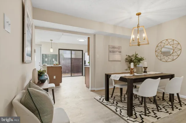 a dining room with furniture a chandelier and window