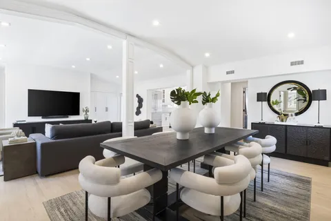 a kitchen with a potted plant on the counter and cabinets