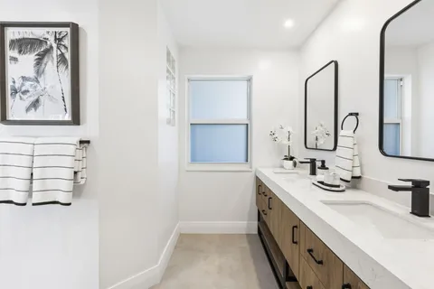 a living room with furniture and a table with wooden floor