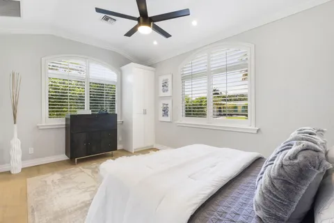 a view of a balcony with chairs and wooden floor