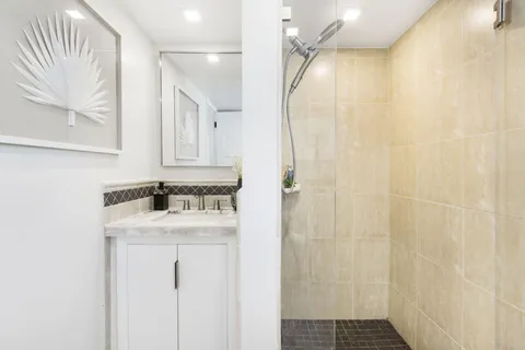 a roof deck with couches and potted plants with sky view