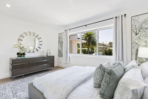 a view of a patio with table and chairs with wooden floor and fence