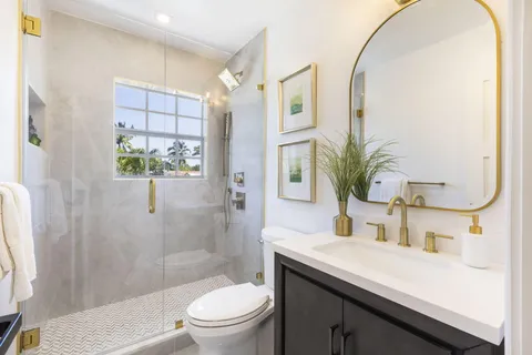 a view of a patio with a table and chairs under an umbrella
