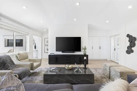a living room with furniture a rug and a flat screen tv