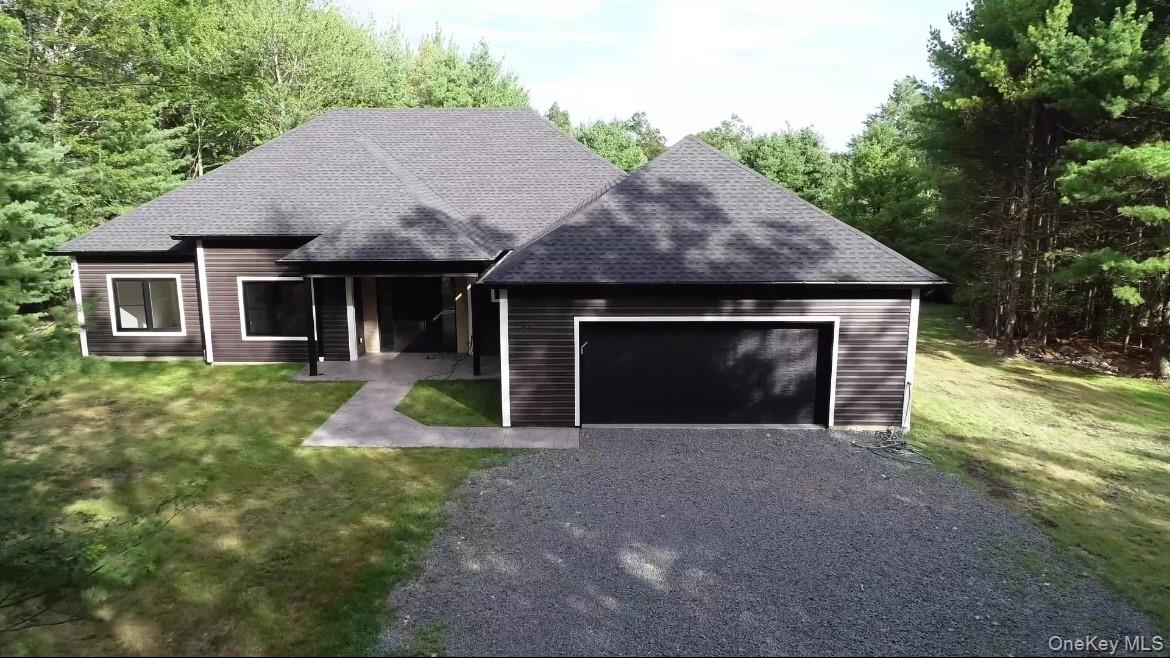 a front view of a house with yard and garage