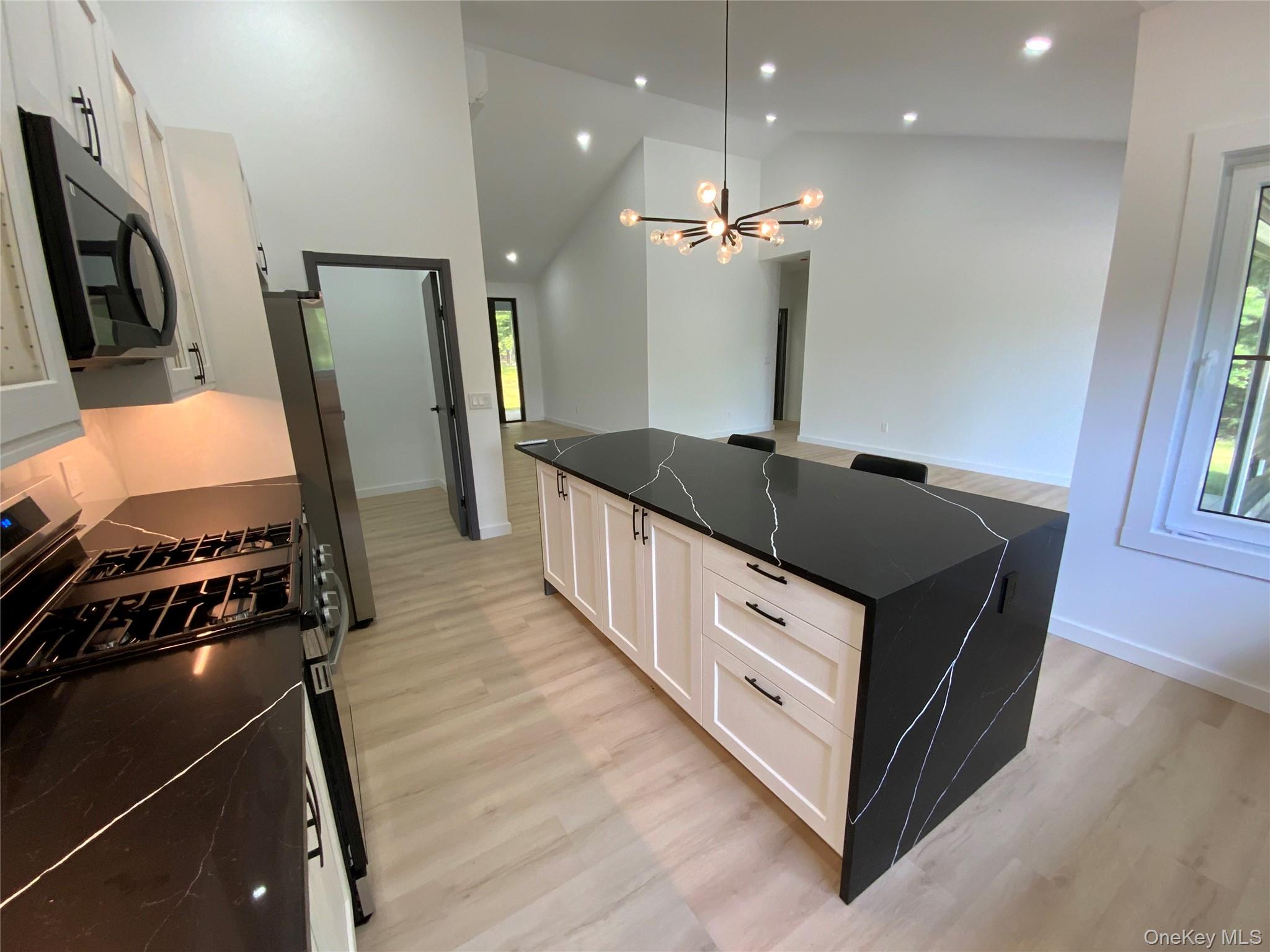 58 Dunn Town Road Wurtsboro, NY 12790 - Photo 11 of 36 a kitchen with granite countertop a sink stove and refrigerator