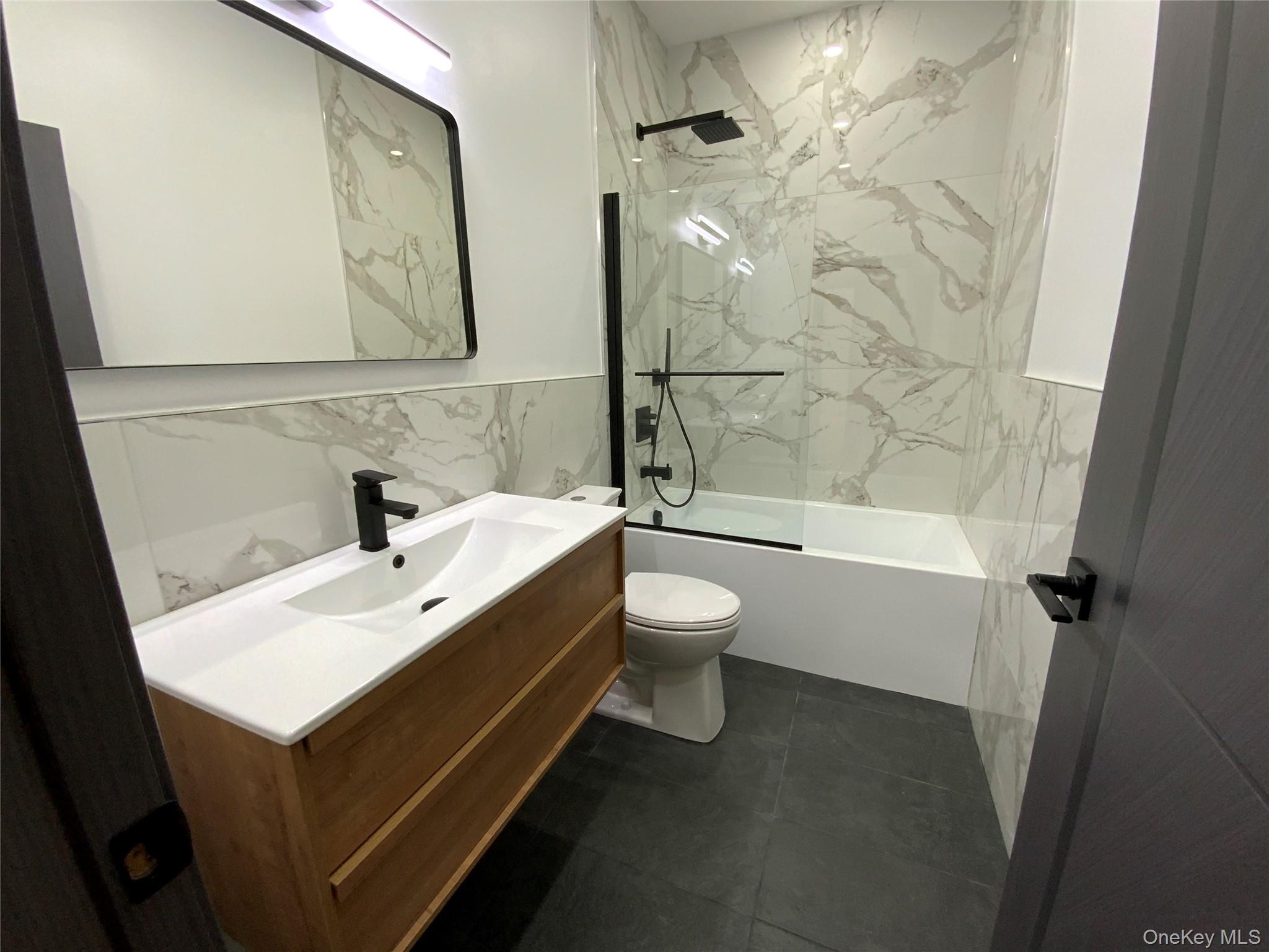 58 Dunn Town Road Wurtsboro, NY 12790 - Photo 12 of 36 a bathroom with a white sink a toilet a mirror and shower