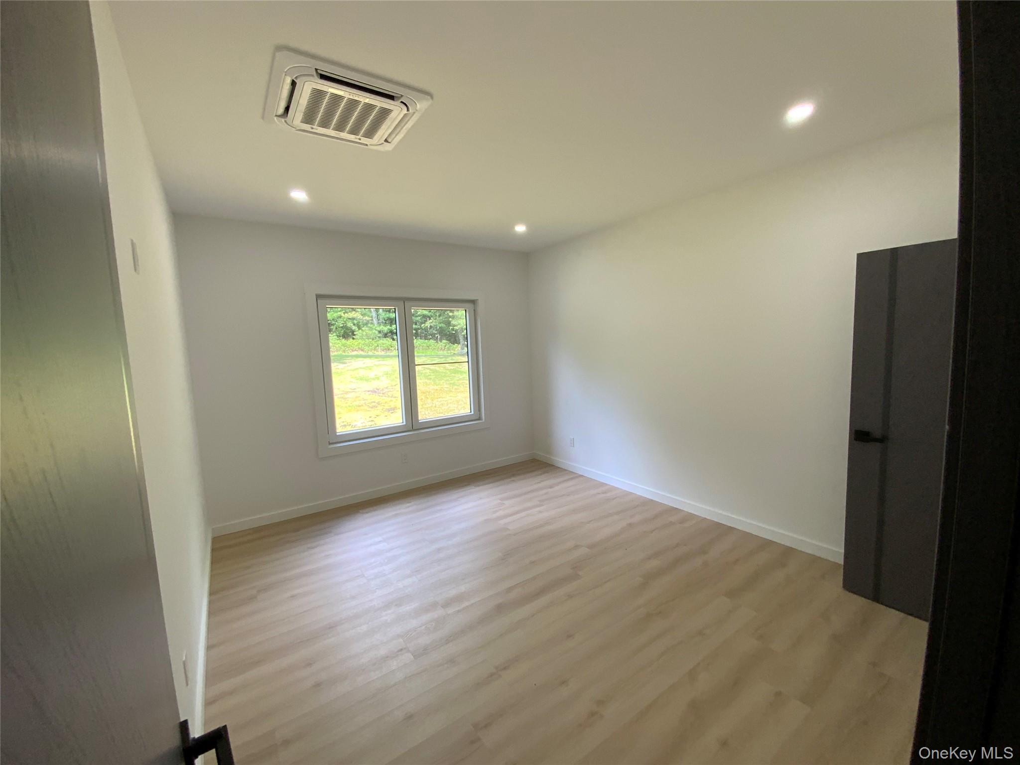 58 Dunn Town Road Wurtsboro, NY 12790 - Photo 13 of 36 an empty room with wooden floor and windows