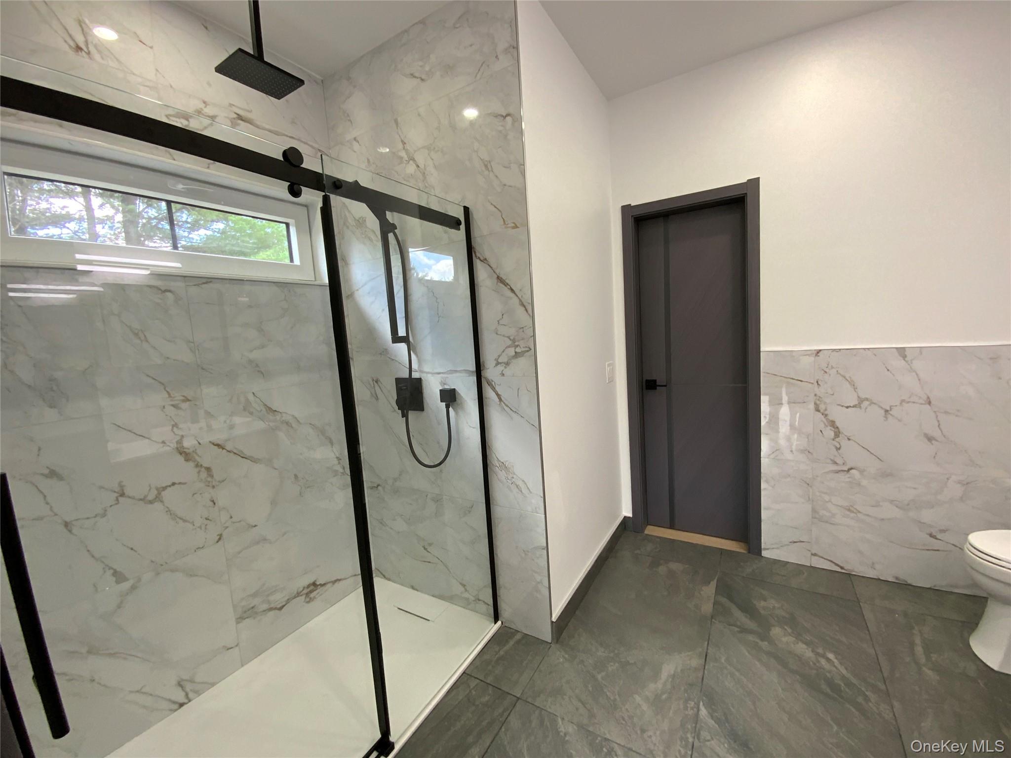 58 Dunn Town Road Wurtsboro, NY 12790 - Photo 15 of 36 a bathroom with a glass shower door