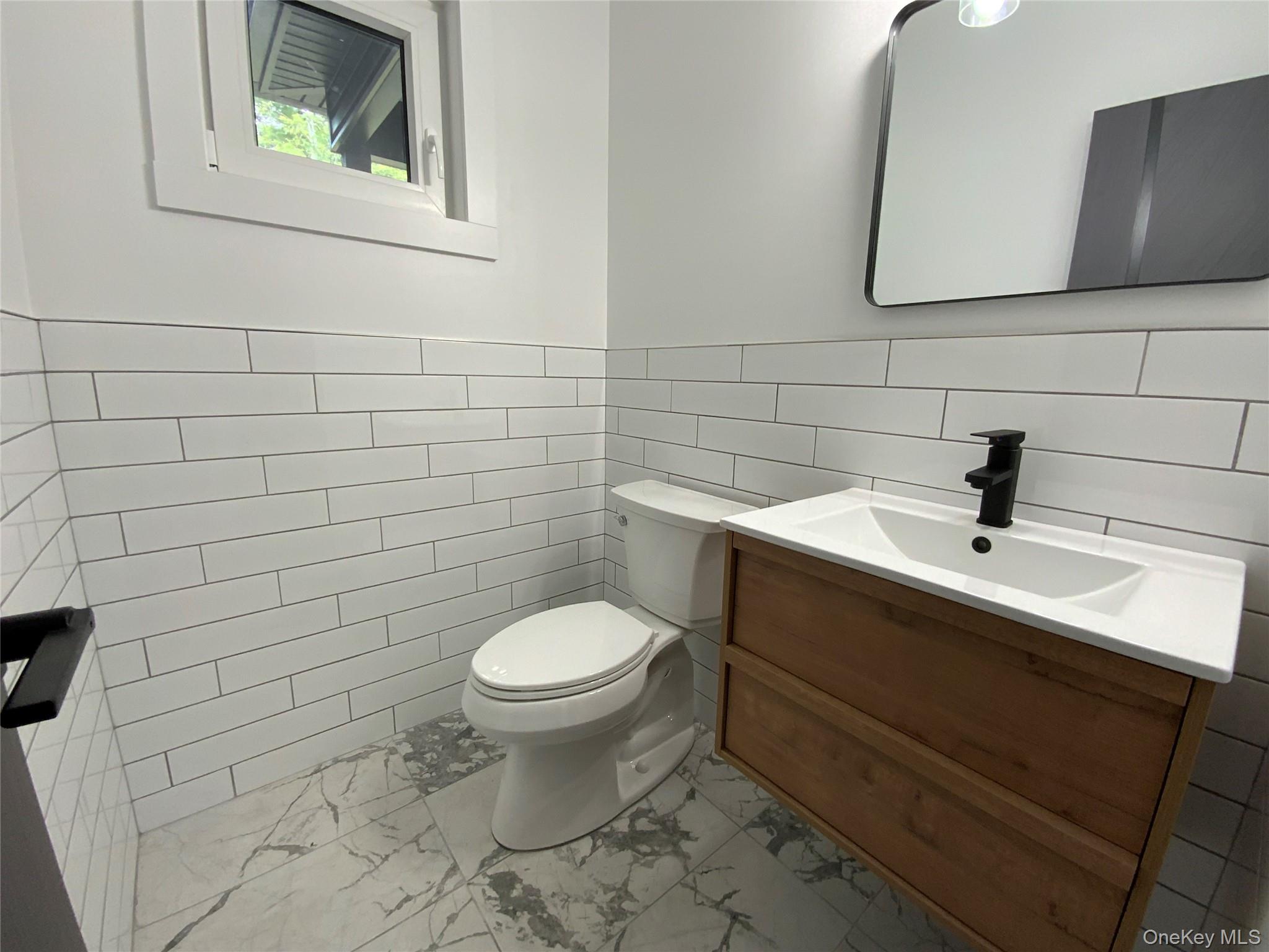 58 Dunn Town Road Wurtsboro, NY 12790 - Photo 16 of 36 a bathroom with a toilet sink and mirror