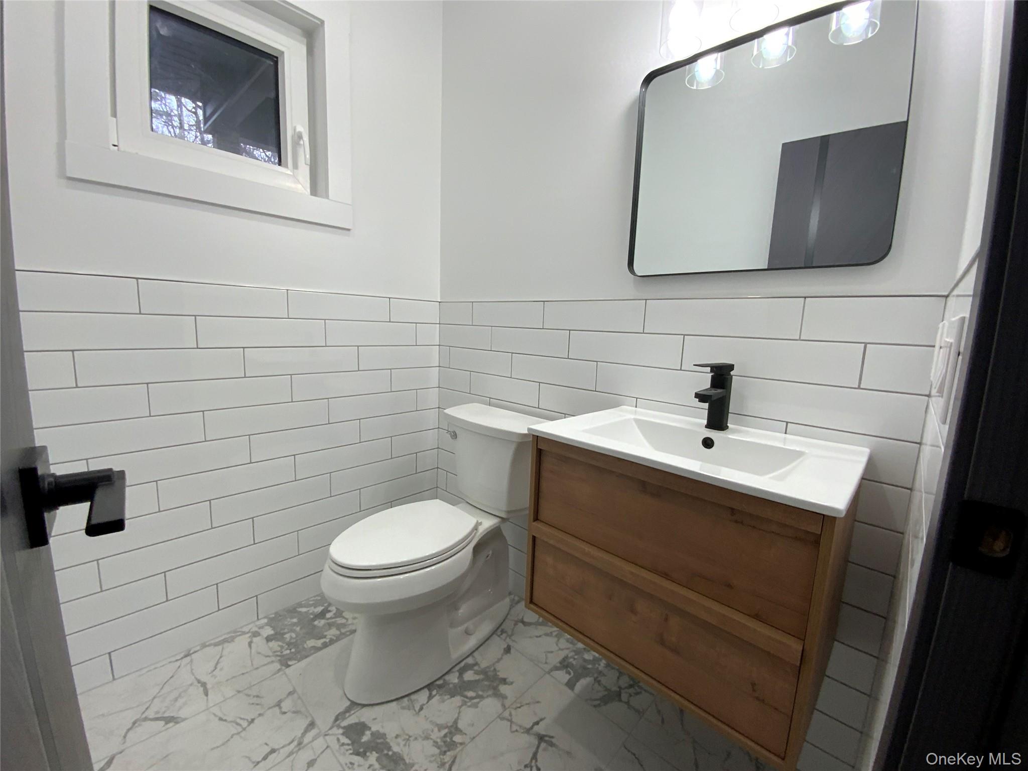 58 Dunn Town Road Wurtsboro, NY 12790 - Photo 20 of 36 a bathroom with a toilet sink and mirror