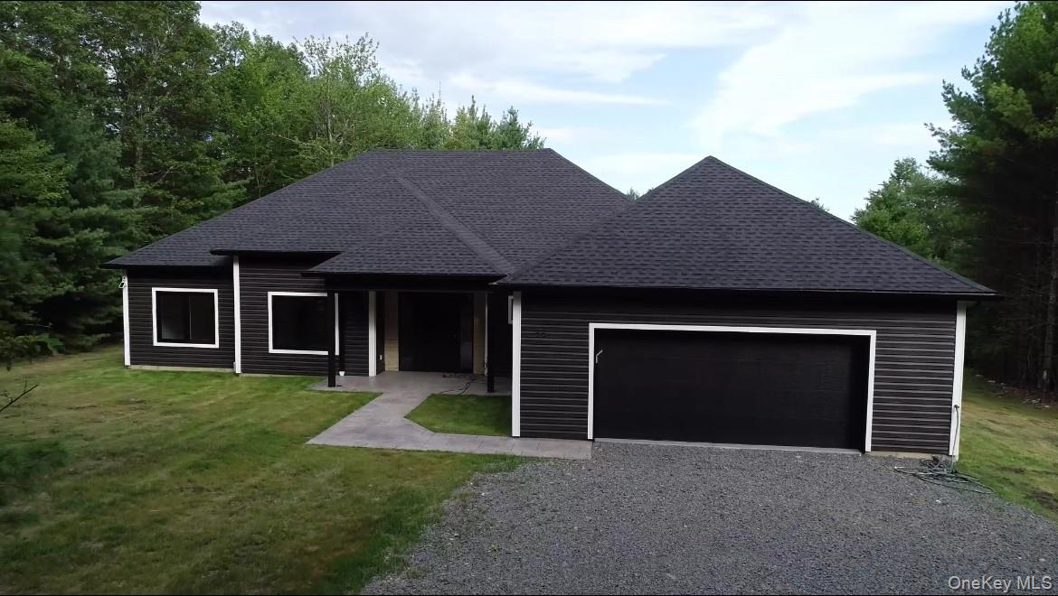 58 Dunn Town Road Wurtsboro, NY 12790 - Photo 2 of 36 a front view of a house with a yard and garage