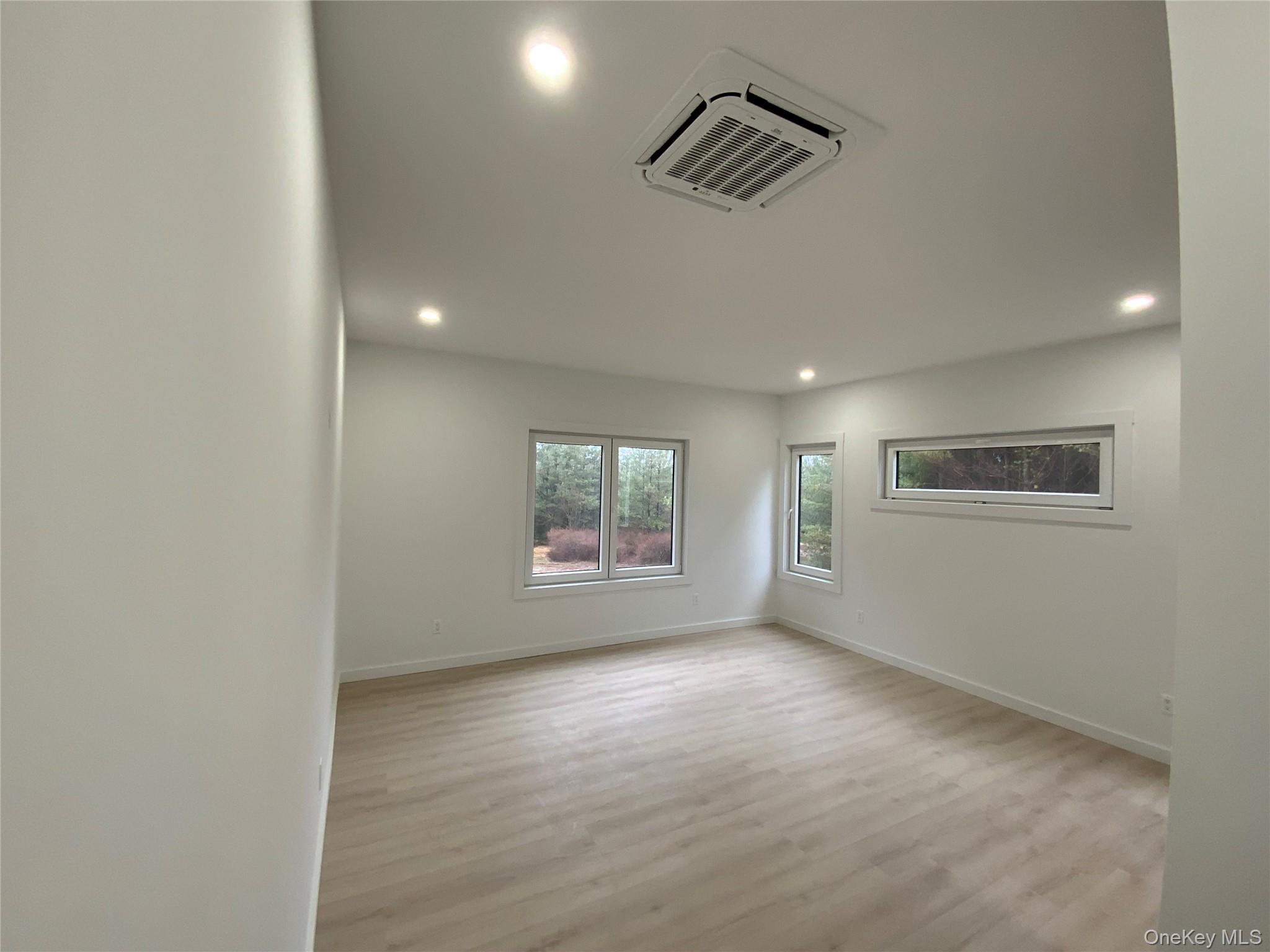 58 Dunn Town Road Wurtsboro, NY 12790 - Photo 22 of 36 an empty room with windows and cabinet
