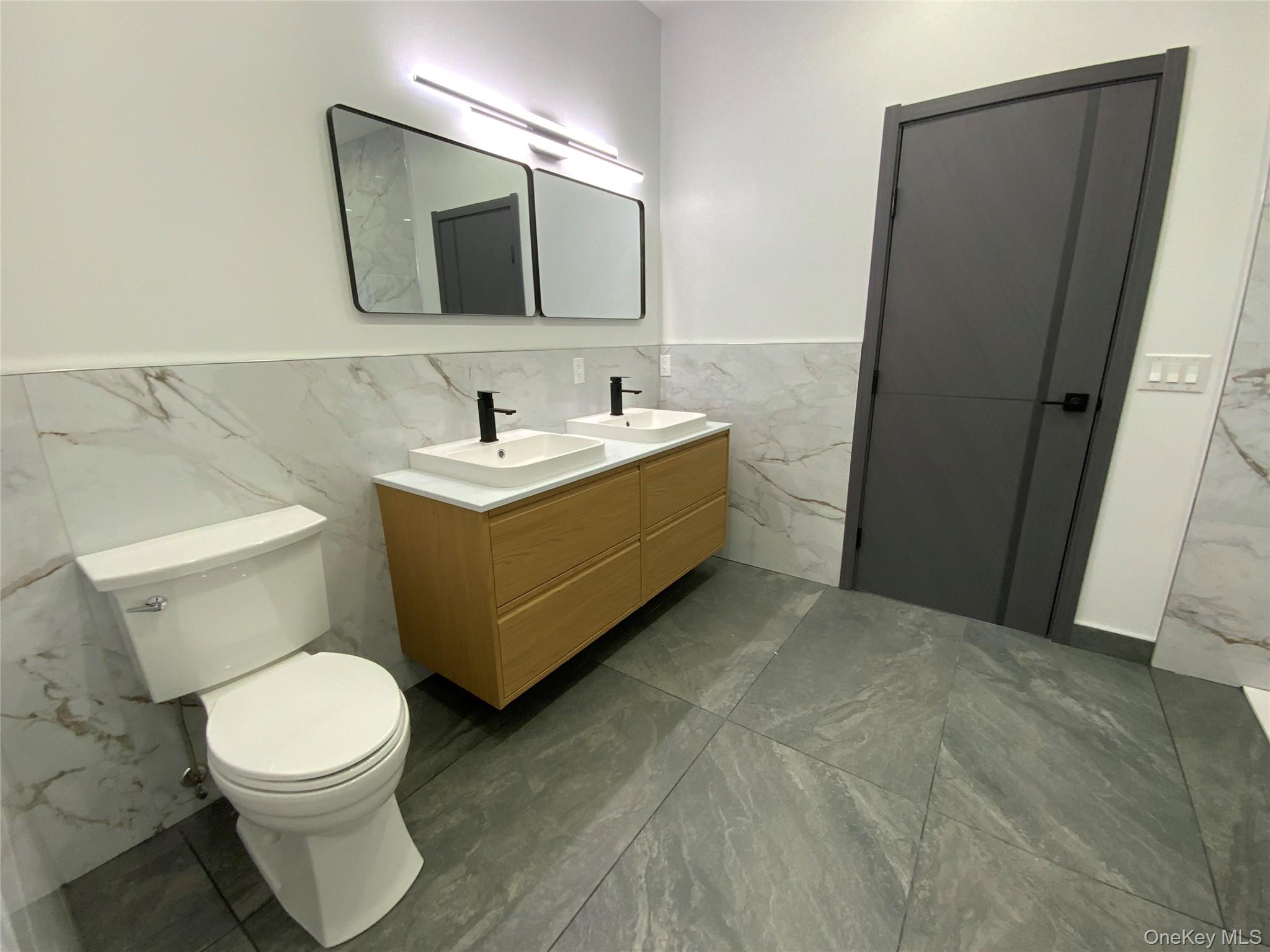 58 Dunn Town Road Wurtsboro, NY 12790 - Photo 23 of 36 a bathroom with a toilet sink and mirror