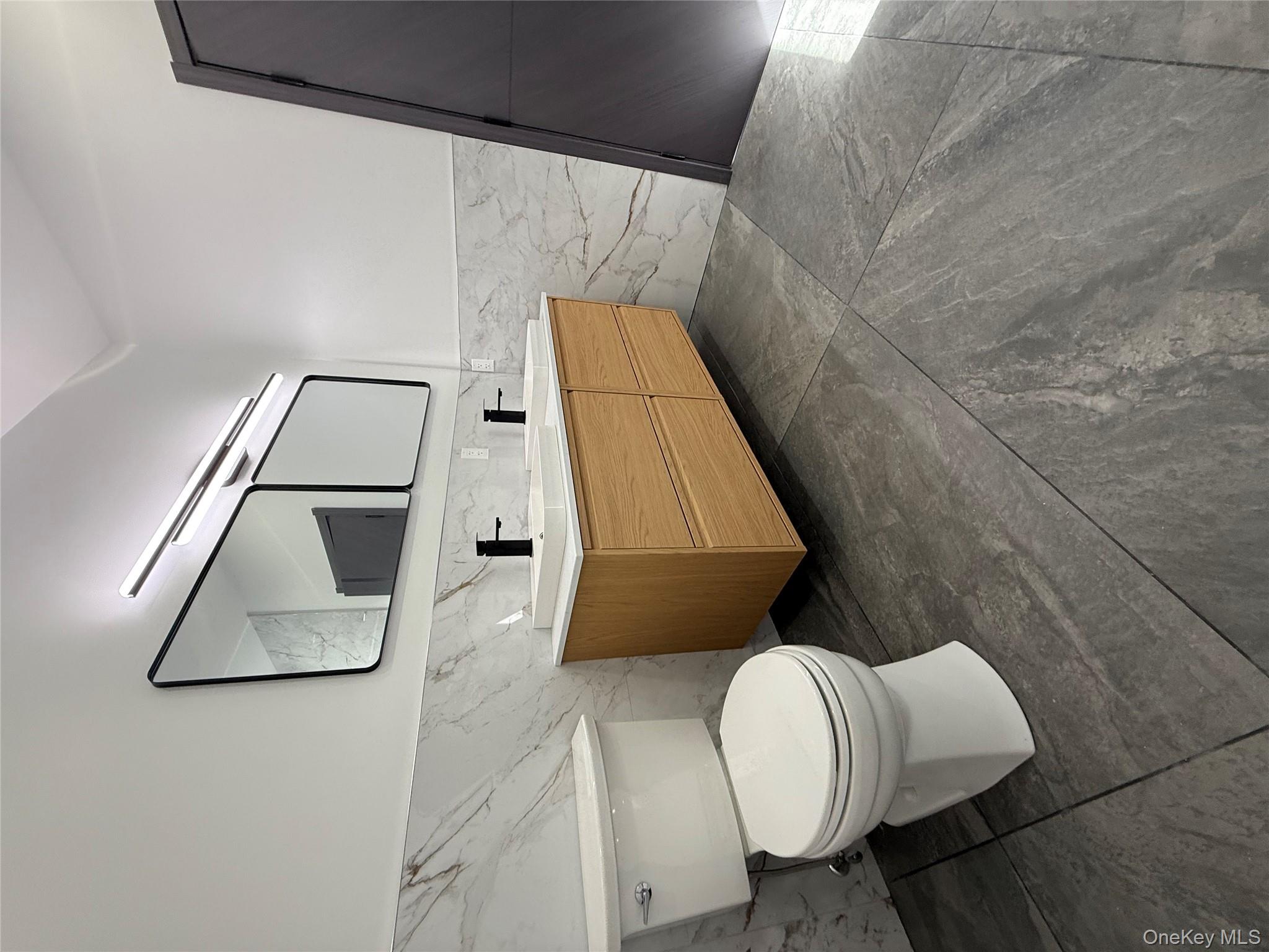 58 Dunn Town Road Wurtsboro, NY 12790 - Photo 26 of 36 a bathroom with a toilet sink and mirror