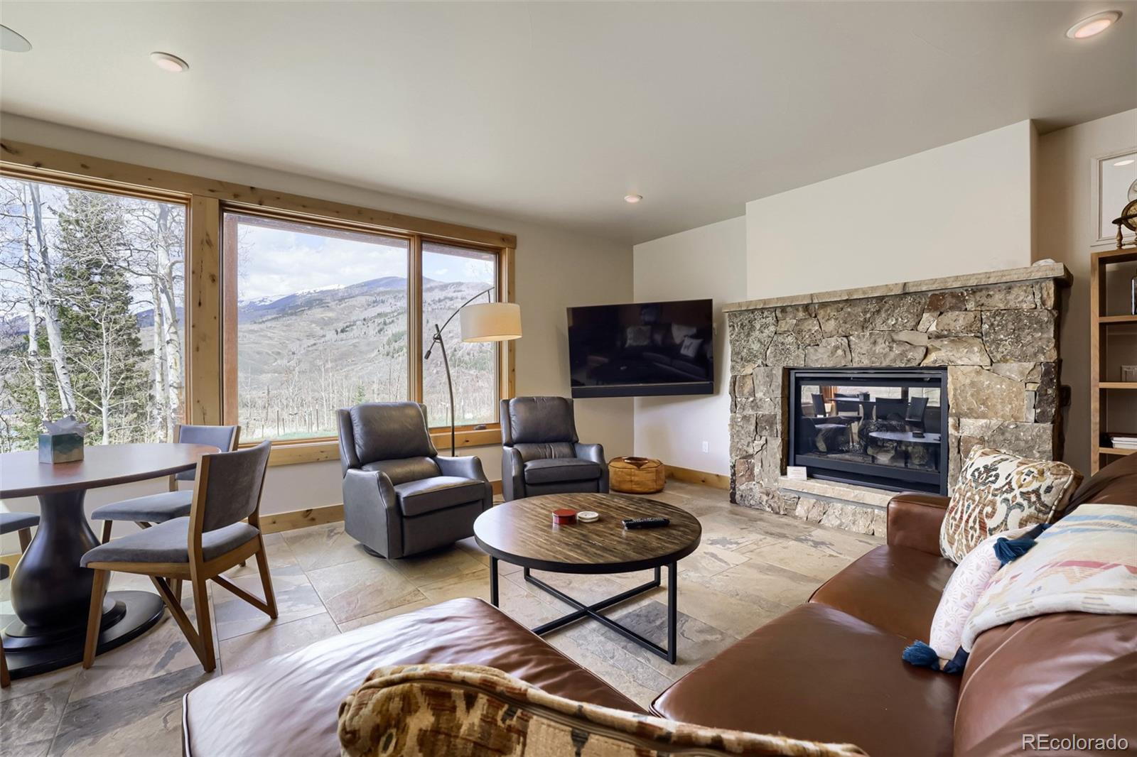 836 Maryland Creek Road Silverthorne, CO 80498 - Photo 15 of 49 a living room with furniture and a fireplace