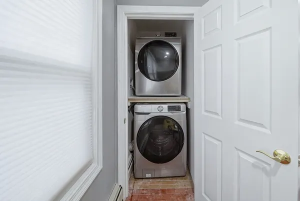 a view of a hallway with washer and dryer