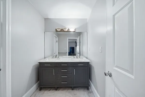 a bathroom with a granite countertop sink a mirror and a vanity